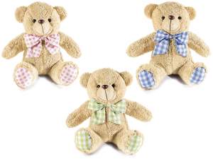 Plush teddy bear with bow and checkered paws
