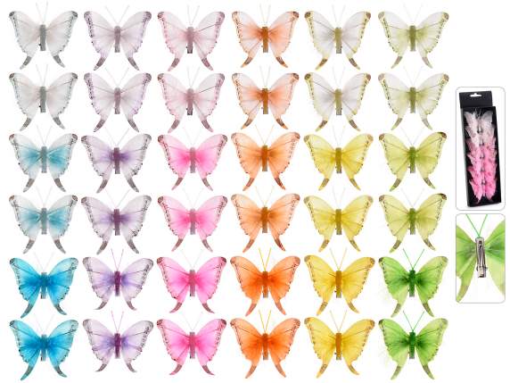 Caja de 6 mariposas de colores con plumas y clips metálicos.