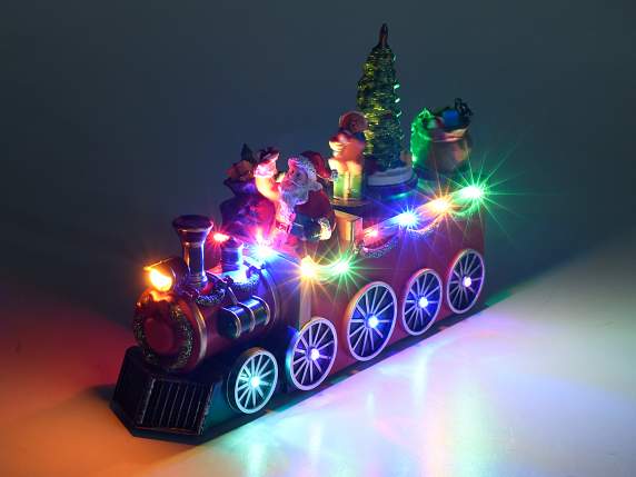 Moș Crăciun într-un tren cu mișcare, lumini multicolore și m