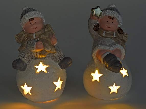 Boy-girl in colored ceramic on a snow globe with LED light