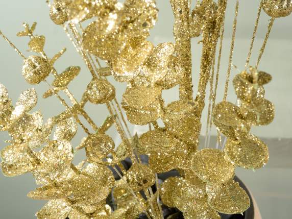 Branch of gold glitter artificial leaves and berries