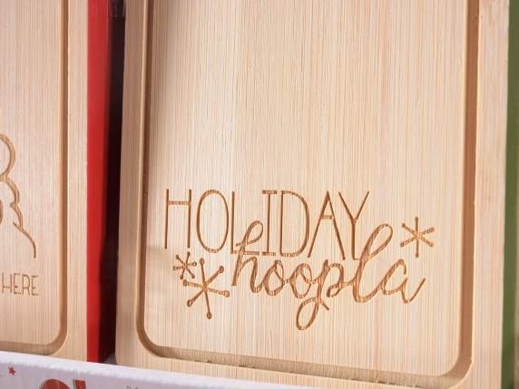 Carved wooden cutting board with Christmas decorations on di