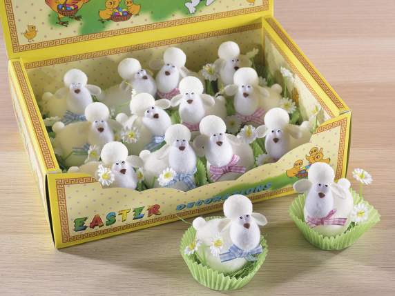 Display with 12 little sheep with daisy on a clod of grass