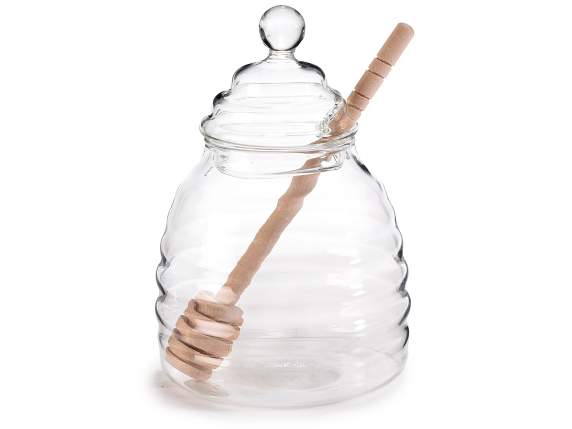 Glass honey jar with wooden honey scoop
