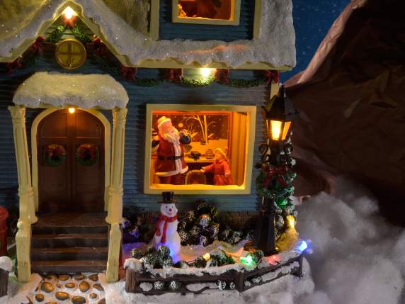 Casa navideña con luces multicolores, movimiento y música.