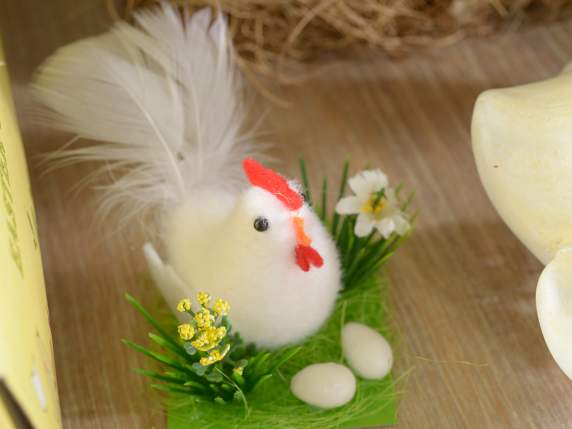Exposición de 12 gallinas con huevos y flores sobre el céspe