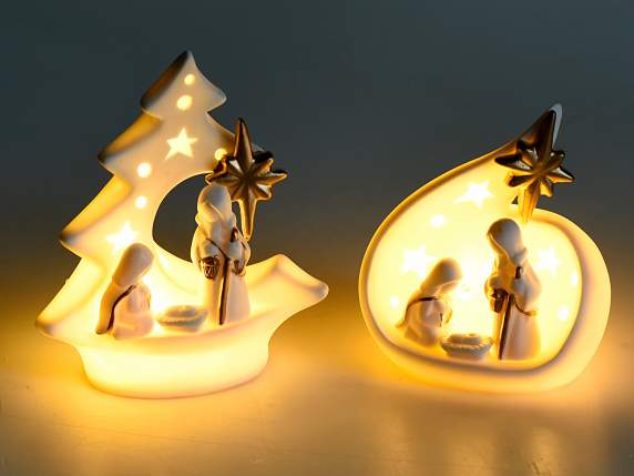 White ceramic nativity scene with gold-colored details and L
