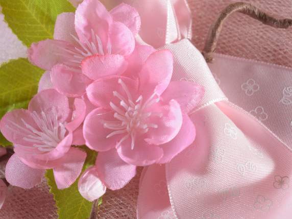 Artificial bouquet of peach blossoms with leaves