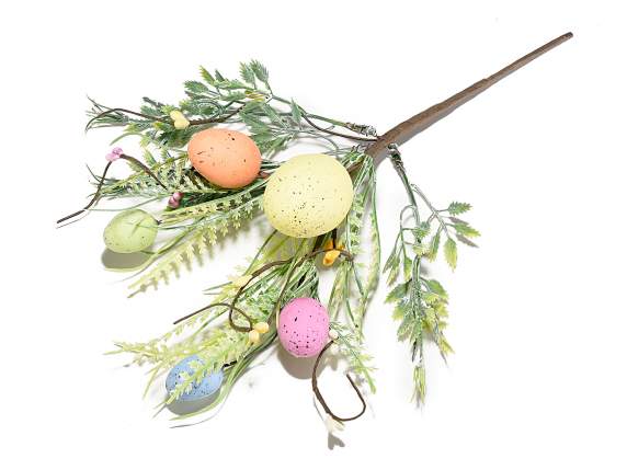 Artificial colored eggs and leaves branch
