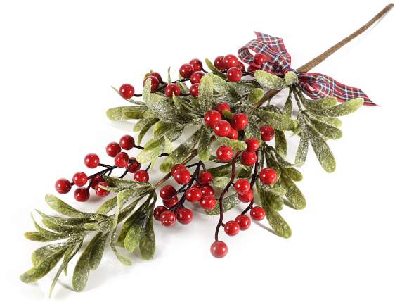 Red berry branch with snowy leaves and bow