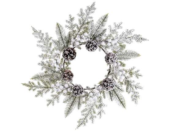 Wreath of pine branches, berries and snow-covered pine cones