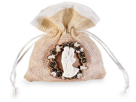 Mesh bag with wooden decoration, plaster bride and groom and