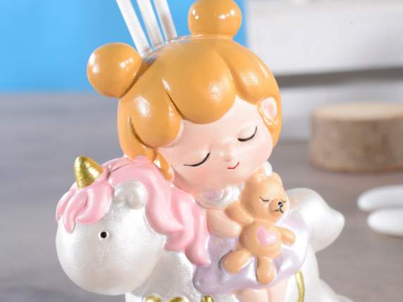 Little girl on porcelain rocking unicorn with stick and perf