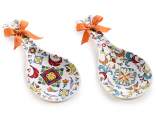 Ceramic spoon rest with majolica relief decorations and bow