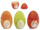 Scented candle in egg-shaped glass jar with lid