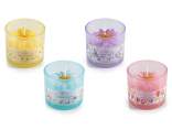 Scented flower candle in a colored glass jar