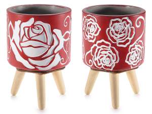 Cement vase on wooden tripod with rose decoration