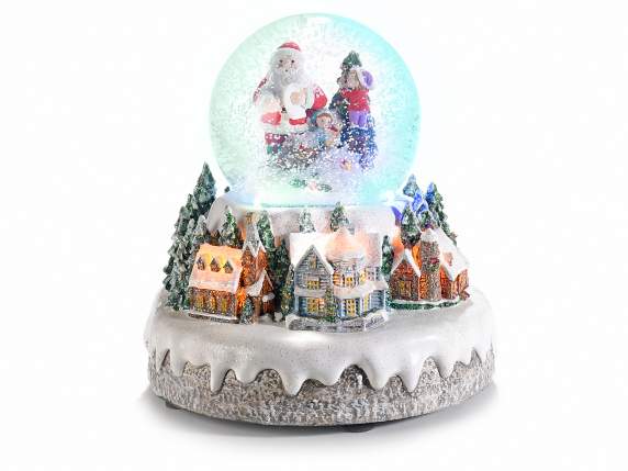 Paisaje navideño con bola de nieve, luces multicolores y mús