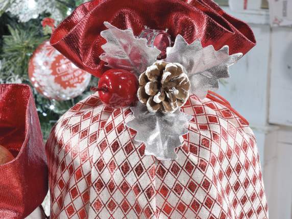 Sprig with snow-covered pine cone and decorations