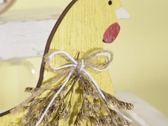 Wooden hen on flower meadow with bird and bow