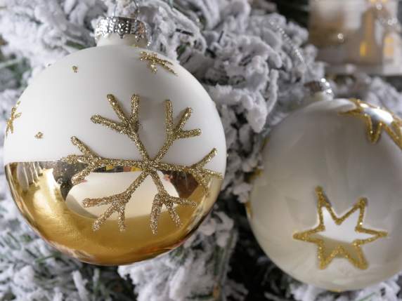 Glass ball with golden glitter decorations in display