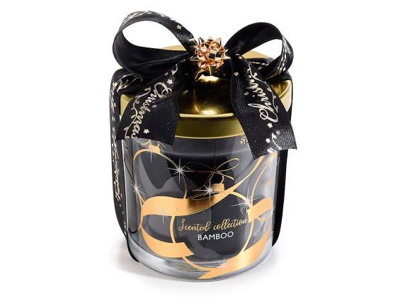 Scented candle in a jar with lid and golden decorations