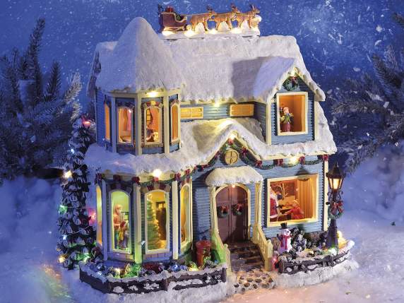 Casa navideña con luces multicolores, movimiento y música.
