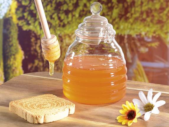 Tarro de miel de vidrio con pala de madera para miel.