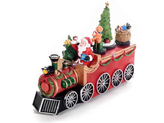 Santa Claus en un tren con movimiento, luces multicolores y