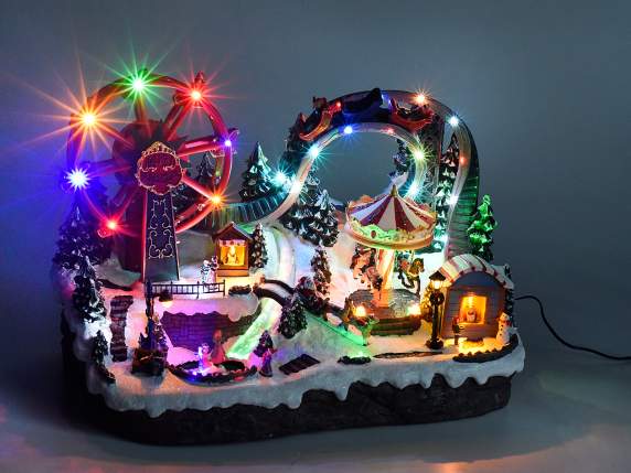 Parc avec manèges en résine, lumières multicolores, musique