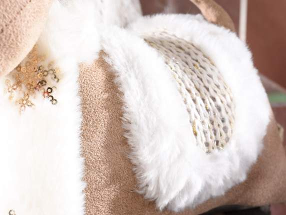 Reindeer lying in fabric with golden details and bell