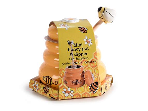 Tarro de miel de cerámica con pala de madera para miel.