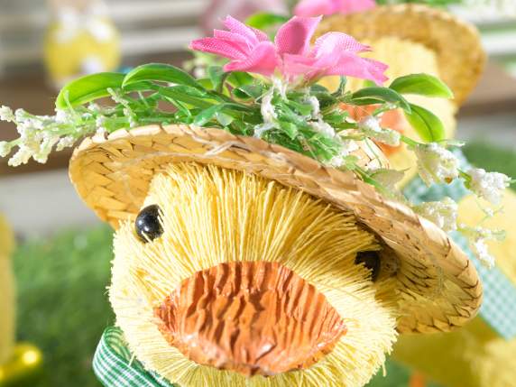 Canard en fibre naturelle avec chapeau fleuri pour se repose