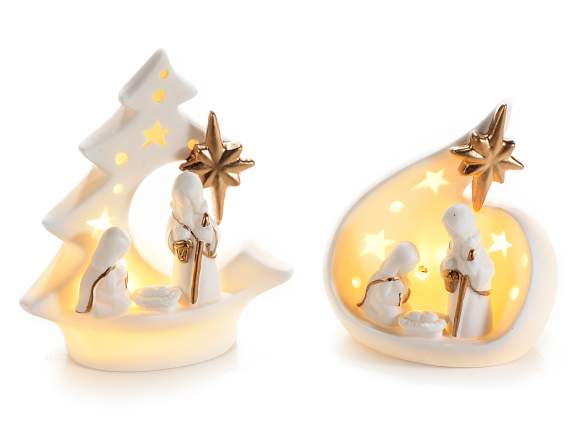 White ceramic nativity scene with gold-colored details and l