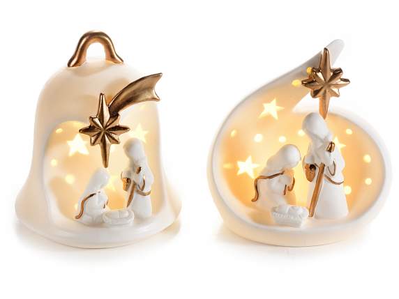 White ceramic nativity scene with gold-colored details and l