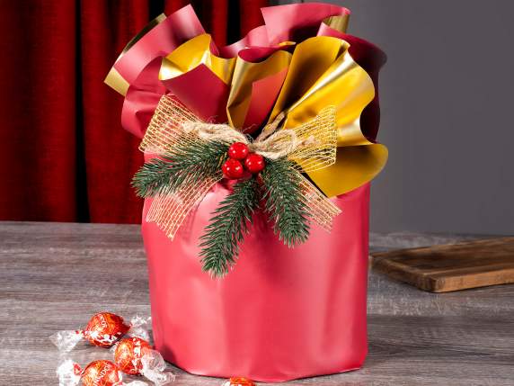 Sprig of pine needles and red berries with a string bow