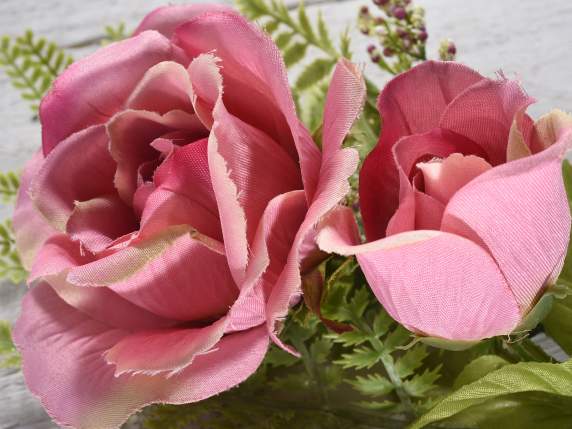 Sprig of artificial rose with bud and small flowers