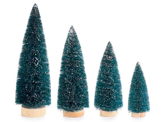 Set of 4 snow covered artificial Christmas trees on wooden b