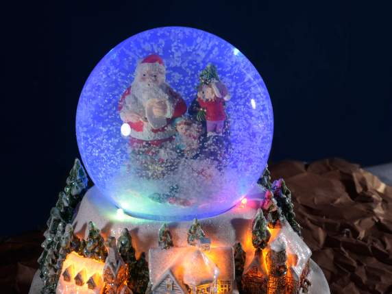 Christmas landscape with snowball, multicolor lights and mus