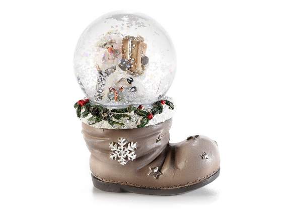 Christmas snowball on resin boot on display