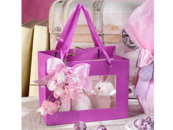 Small colored paper bag with fabric handles and window