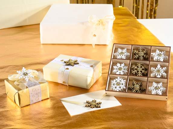 Display 27 wooden snowflake decorations with tape