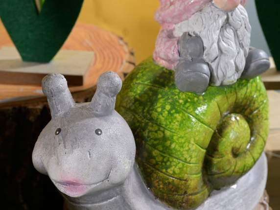 Terracotta garden gnome on animal