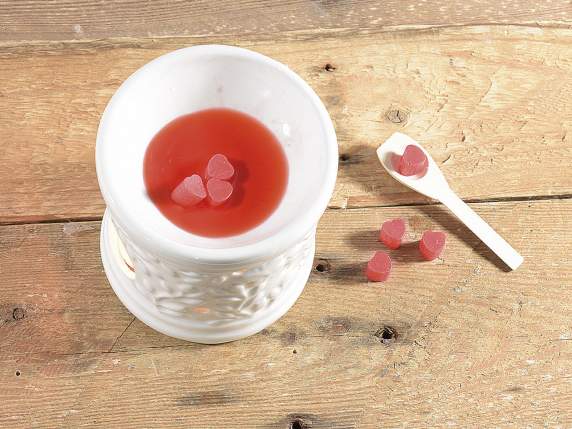 Small scented wax heart into a glass jar with wooden spoon