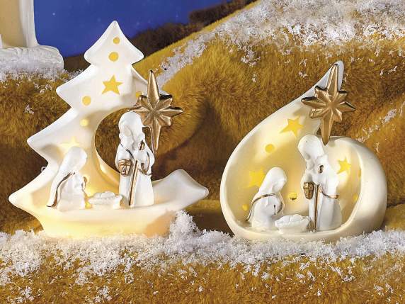 White ceramic nativity scene with gold-colored details and L
