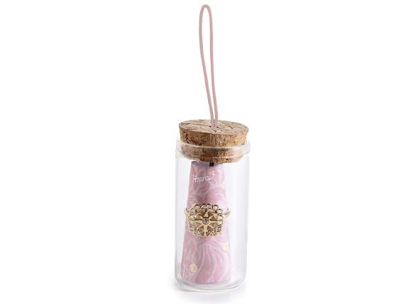 Metal ring with rhinestones in test tube