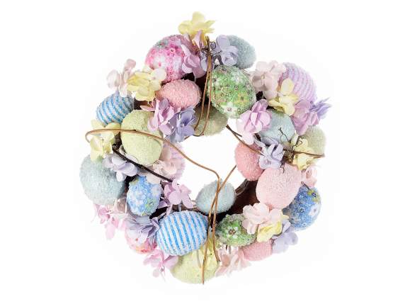 Wreath with decorated colored eggs and peach blossoms