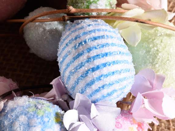 Wreath with decorated colored eggs and peach blossoms