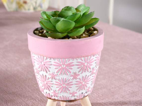 Decorated concrete vase on wooden tripod