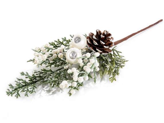 Artificial sprig of white berries and snow-covered pine cone